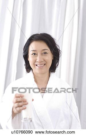 Senior woman holding a glass of milk View Large Photo Image Stock Image - Senior woman holding a glass of milk. Fotosearch