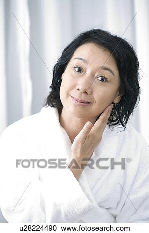 Senior woman in bathrobe touching face, smiling, portrait View Large Photo Image Stock Image - Senior woman in bathrobe touching face, smiling, portrait. Fotosearch