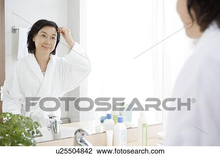 Senior woman looking in mirror View Large Photo Image Stock Image - Senior woman looking in mirror. Fotosearch