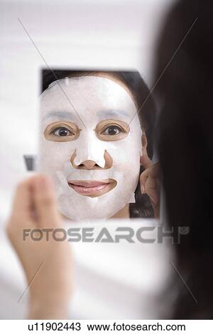 Senior woman with facial mask looking in mirror, reflection View Large Photo Image Stock Image - Senior woman with facial mask looking in mirror, reflection. Fotosearch