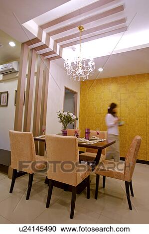 Young woman in dining room View Large Photo Image Stock Image - Young woman in dining room. Fotosearch