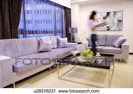 Young woman in living room View Large Photo Image Stock Image - Young woman in living room. Fotosearch