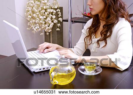 Young woman using laptop View Large Photo Image Stock Image - Young woman using laptop. Fotosearch