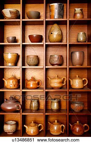 Stock Image - Assorted potteries on shelf, close up. Fotosearch