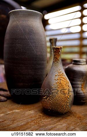 Stock Image - Ceramic pots with charcoal ash. Fotosearch