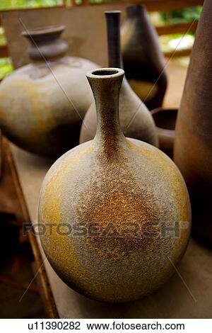 Stock Image - Ceramic pots with coal ash. Fotosearch