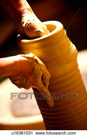 Hands of potter at work throwing pot on wheel View Large Photo Image Stock Image - Hands of potter at work throwing pot on wheel. Fotosearch