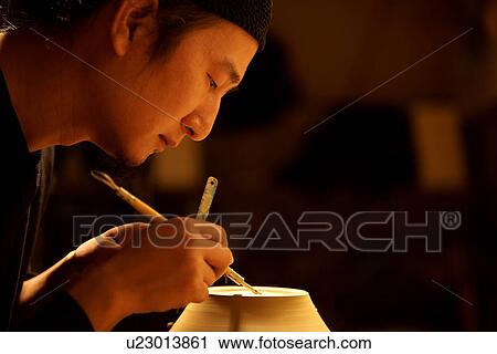 Stock Image - Potter making a vase, carving. Fotosearch