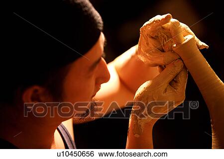 Stock Photograph - Potter pinching a vase. Fotosearch