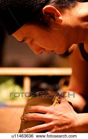 Stock Photograph - Potter pinching a vase. Fotosearch