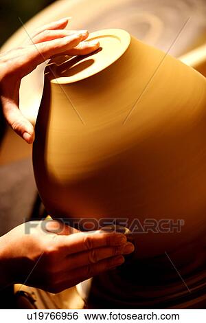 Stock Photograph - Potter polishing clay, close up of hands. Fotosearch
