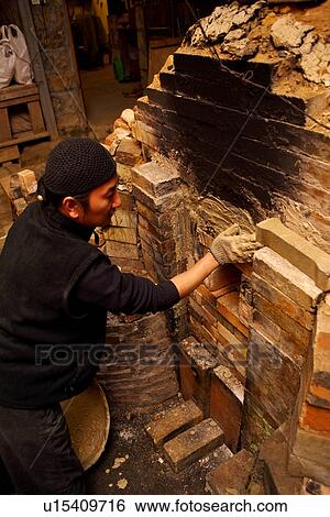 Stock Photograph - Potter working, side view. Fotosearch