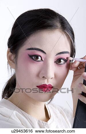 Stock Photograph - Beijing Opera performer preparing make-up. Fotosearch