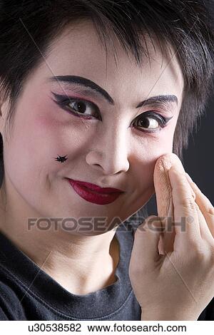 Stock Image - Female opera performer using powder puff. Fotosearch