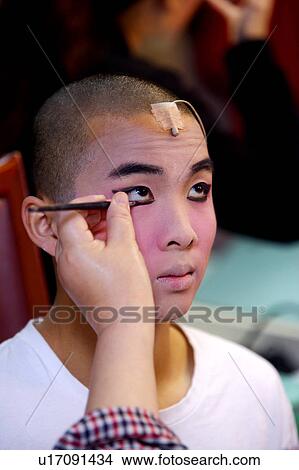 Makeup artists applying makeup to actor's eyes View Large Photo Image Picture - Makeup artists applying makeup to actor's eyes. Fotosearch