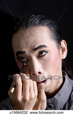 Male performer applying stage make-up View Large Photo Image Stock Image - Male performer applying stage make-up. Fotosearch