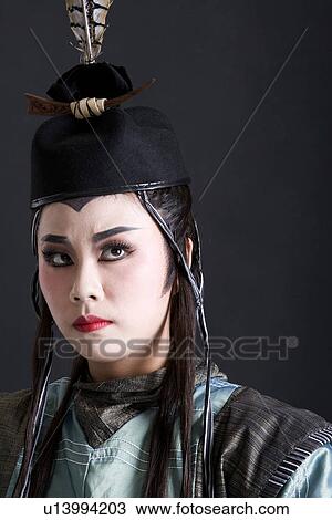 Stock Image - Mature man wearing traditional clothing and hat, side view. Fotosearch