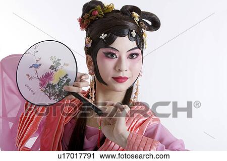 Mature woman wearing traditional clothing holding fan View Large Photo Image Stock Image - Mature woman wearing traditional clothing holding fan. Fotosearch