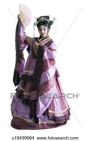 Picture - Mature woman with fan wearing traditional clothing. Fotosearch