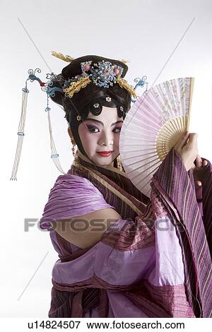 Stock Photo - Mature woman with fan wearing traditional clothing. Fotosearch