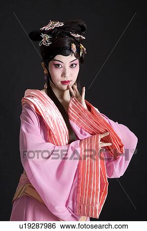 Stock Photograph - Portrait of Beijing opera performer in traditional dress and make up. Fotosearch