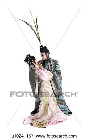 Woman and man wearing traditional clothing looking at each other View Large Photo Image Stock Photo - Woman and man wearing traditional clothing looking at each other. Fotosearch