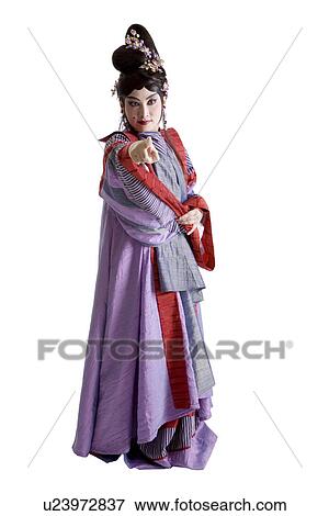 Woman wearing traditional clothing pointing a direction View Large Photo Image Stock Photo - Woman wearing traditional clothing pointing a direction. Fotosearch