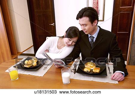 Stock Image - Couple eating breakfast. Fotosearch
