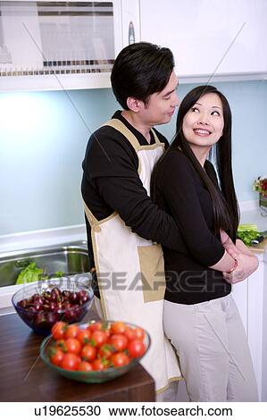 Couple embracing in kitchen View Large Photo Image Stock Image - Couple embracing in kitchen. Fotosearch