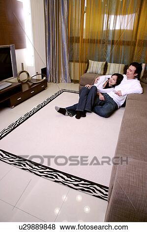 Couple embracing sitting on floor View Large Photo Image Stock Photo - Couple embracing sitting on floor. Fotosearch