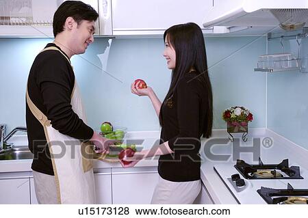 Stock Photo - Couple in kitchen. Fotosearch