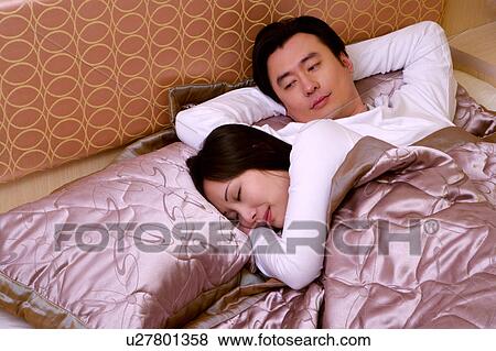 Stock Photo - Couple on bed. Fotosearch