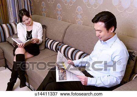 Stock Photo - Couple on sofa. Fotosearch