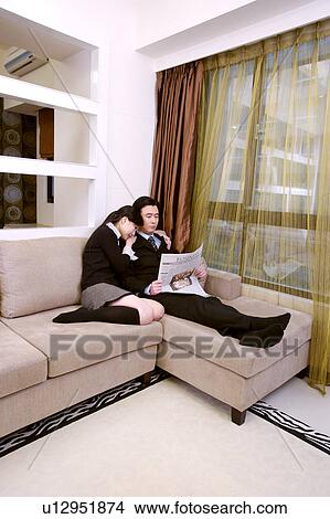 Couple reading newspaper together View Large Photo Image Picture - Couple reading newspaper together. Fotosearch