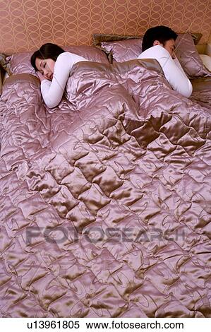Stock Photography - Couple sleeping on bed. Fotosearch