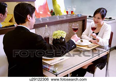 Couple toasting with a glass of red wine View Large Photo Image Stock Photograph - Couple toasting with a glass of red wine. Fotosearch