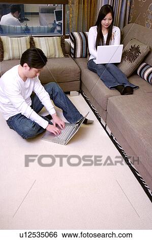 Stock Photograph - Couple using laptop. Fotosearch
