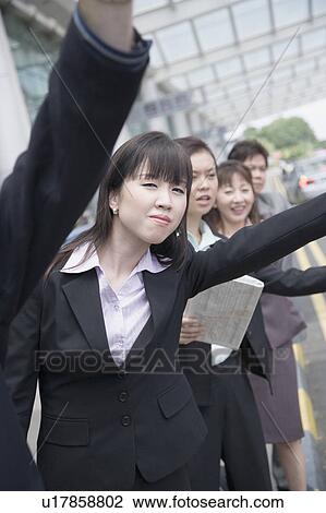 Business executives hailing a taxi at an airport View Large Photo Image Stock Image - Business executives hailing a taxi at an airport. Fotosearch
