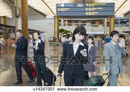 Stock Photo - Business executives leaving an airport. Fotosearch