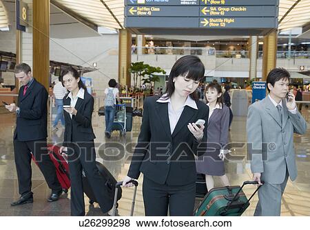 Business executives leaving an airport View Large Photo Image Stock Photo - Business executives leaving an airport. Fotosearch