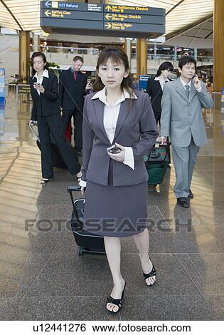 Business executives leaving an airport View Large Photo Image Stock Photograph - Business executives leaving an airport. Fotosearch