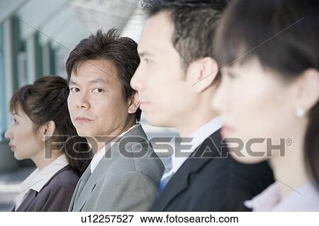 Portrait of a businessman with his three colleagues beside him View Large Photo Image Stock Photo - Portrait of a businessman with his three colleagues beside him. Fotosearch