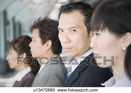 Portrait of a businessman with his three colleagues beside him View Large Photo Image Stock Photography - Portrait of a businessman with his three colleagues beside him. Fotosearch
