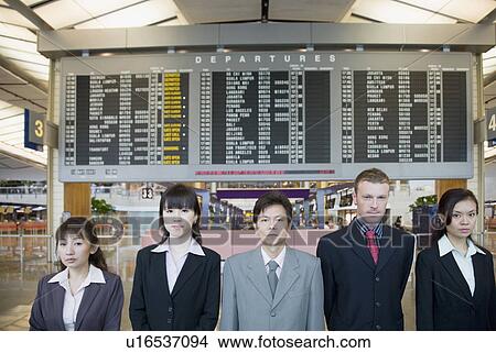 Portrait of five business executives standing in front of an arrival departure board at an airport View Large Photo Image Picture - Portrait of five business executives standing in front of an arrival departure board at an airport. Fotosearch