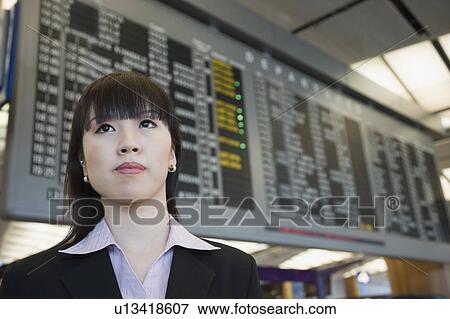 Stock Photo - Close-up of a businesswoman at an airport. Fotosearch