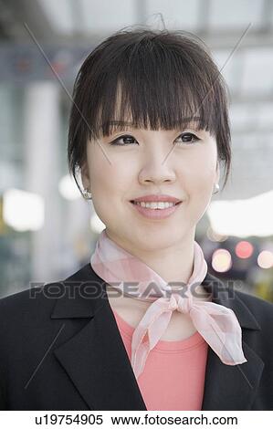 Close-up of a female cabin crew smiling View Large Photo Image Stock Photography - Close-up of a female cabin crew smiling. Fotosearch