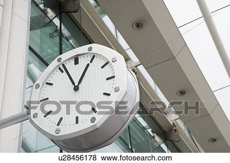 Stock Photo - Low angle view of a clock outside an airport. Fotosearch
