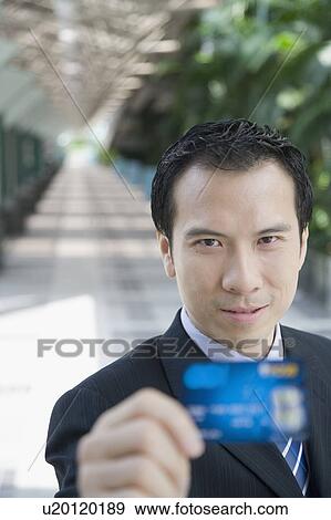 Portrait of a businessman showing a credit card View Large Photo Image Stock Photo - Portrait of a businessman showing a credit card. Fotosearch