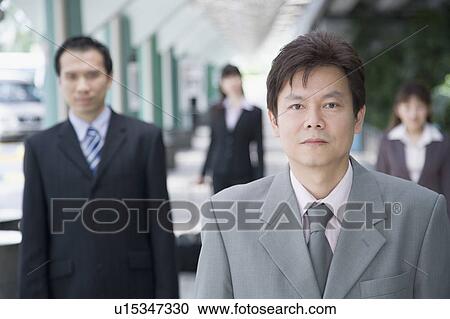 Portrait of a businessman with three business executives in the background View Large Photo Image Stock Image - Portrait of a businessman with three business executives in the background. Fotosearch