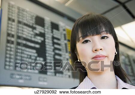 Stock Image - Portrait of a businesswoman at an airport. Fotosearch